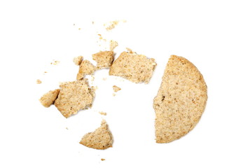 Cracked oatmeal cookie with crumbs isolated on white background, top view