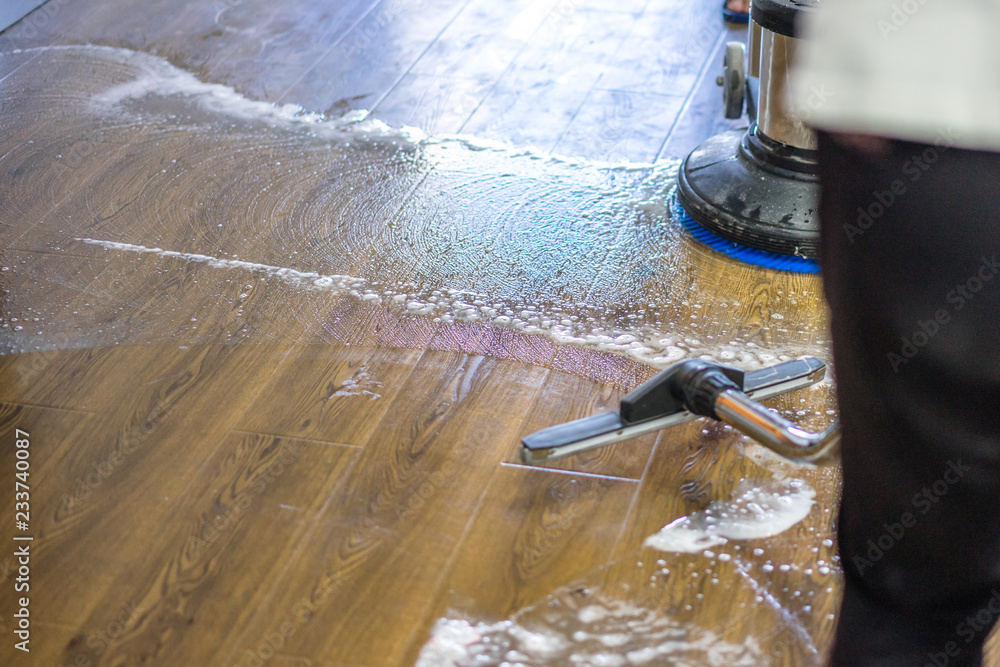 Wall mural cleaning floor with machine