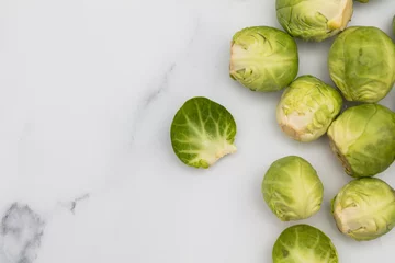 Foto op Aluminium Fresh raw brussel sprouts on a marble background © ink drop