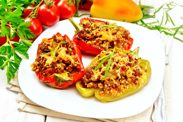 Pepper stuffed with meat and couscous in plate on board
