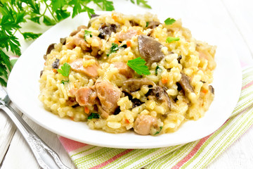Risotto with mushrooms and chicken on table