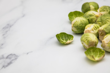 Fresh raw brussel sprouts on a marble background