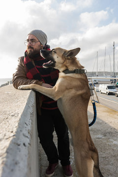 Young Man Walking, Taking Care And Giving Love To His Dog