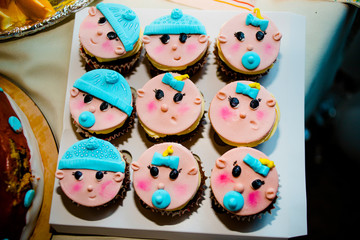Pink cupcakes in the form of a baby