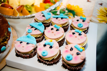 Fototapeta na wymiar Pink cupcakes in the form of a baby