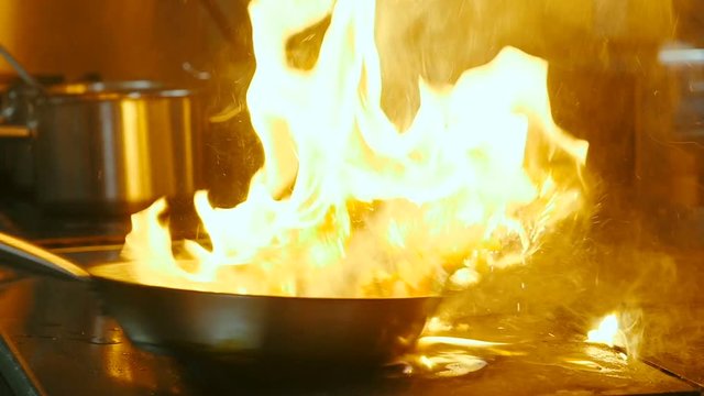 Frying in pan with fire burning