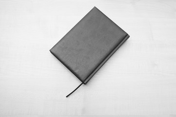 Gray leather diary book laying on wooden table