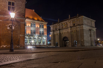 Fototapeta na wymiar Old historic Gate in Gdansk at night, Poland, is one of the city's most notable tourist attractions.