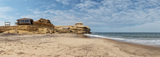 Canyon on Namibe Desert Beach. With wooden houses and porch. Africa. Angola.