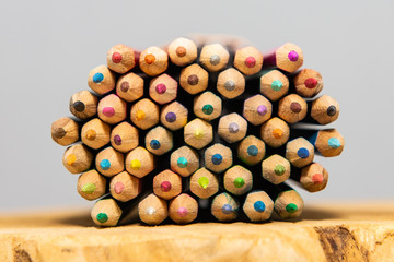 colorful pencils laying on wood.