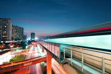 Town centre at night and traffic trails of public transport in Kuala Lumpur,Malaysia.