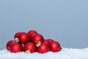 Christmas balls laying in fake snow.