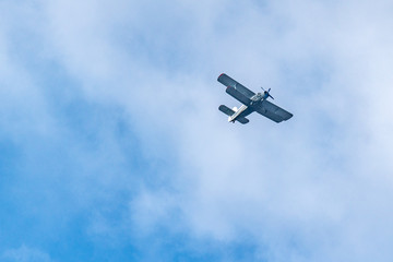 Old retro plane flies in the sky