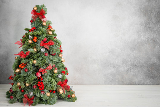 Christmas tree on a grey background with copy space. Image for cards, invitation, prints, posters.