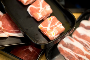 Raw pork for hot pot in black container
