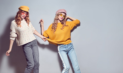 Two Girls Fooling Around. Fashion Autumn Outfit