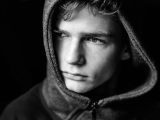 Portrait of a sad, tired, depressed teenager. Problems of teenagers, concept. Black and white photo