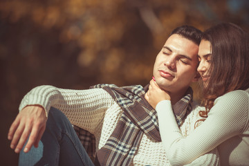 Fototapeta premium Romantic couple hugging and sitting in the park