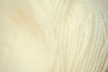 Fototapeta na wymiar white yarn close-up shot. Woolen threads for knitting macro
