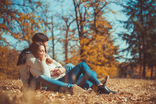 Amorous couple enjoying autumn day outdoors