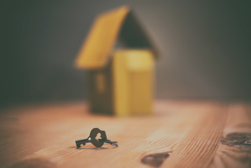 mortgage, investment, real estate and property concept - close up of home model and house keys