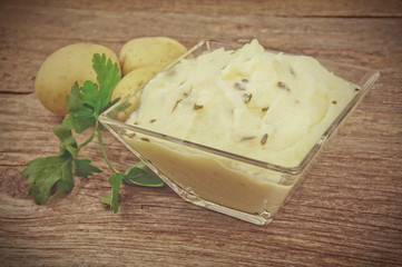 Mashed potatoes on wooden table