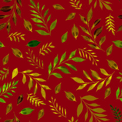 Fototapeta premium Green and brown leaves over a dark red color