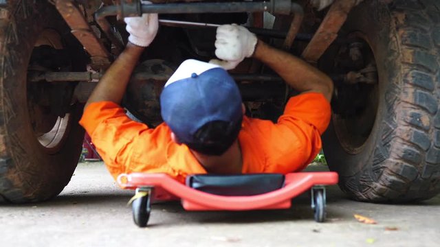 Technicians are working by doing a preliminary inspection of wheel system footage 4K