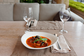 Tomato fish soup on restaurant table