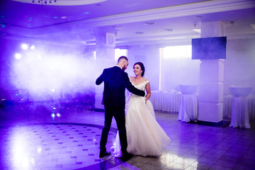 Lovely dance of a young couple in the dance floor