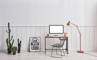 Working room desktop screen orange lamp and chair interior.