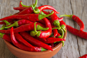 Hot chili peppers on wooden background