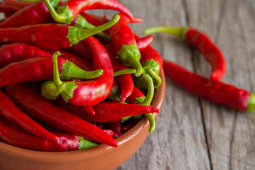 Hot chili peppers on wooden background