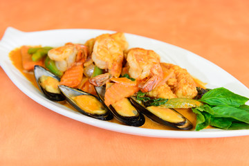 Stir fried shrimp, fish, squid and mussel in Thai red curry paste.