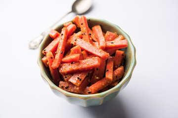 Carrot Pickle / Gajar ka Achar or Loncha in hindi. Served in a bowl over moody background....