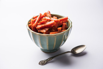Carrot Pickle / Gajar ka Achar or Loncha in hindi. Served in a bowl over moody background....