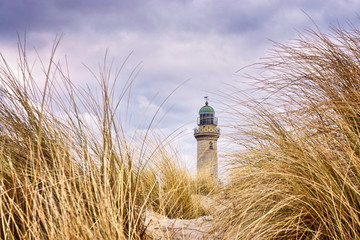 Very close to the dune grass with lighthouse in the background. Warnemünde, Germany