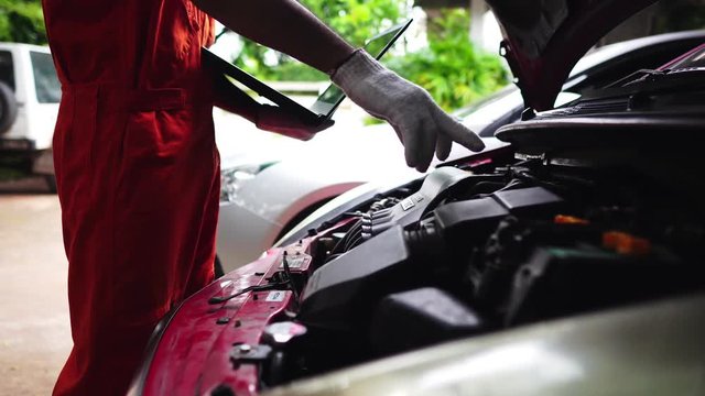 Technicians are working by doing a preliminary inspection of wheel system footage 4K