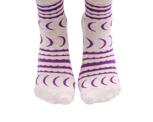 Young woman wearing colorful tail crew socks isolated on white background