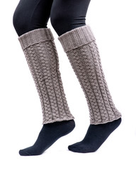 Young woman wearing cable knit leg warmers taupe color isolated on white background