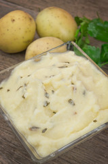 Mashed potatoes on wooden table
