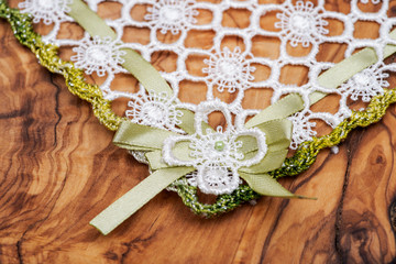 Colorful fabric lace doily on Italian olive wood cutting board