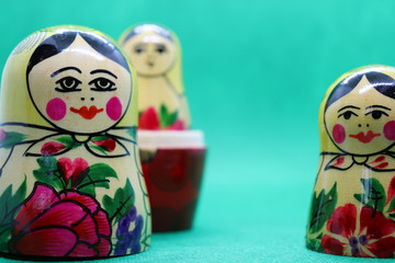 Russian dolls against green background with copy space