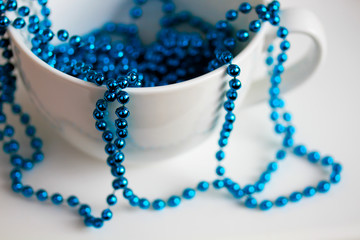 The white mug with blue beads