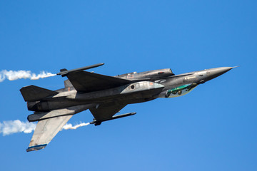 Fototapeta na wymiar fighter jet plane flying upside down