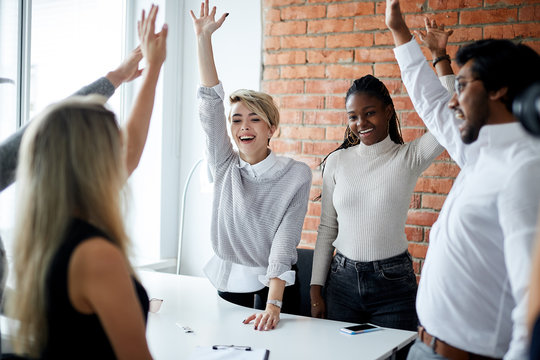 Cheerful Mixed Race Office Workers Celebrating Successful Contract. Luck In Business