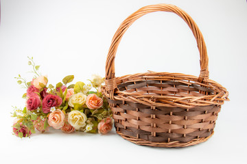 Fototapeta na wymiar empty vintage wicker basket with roses flower on copy space 