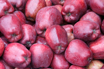 A lot of red apples of starking variety at market stall