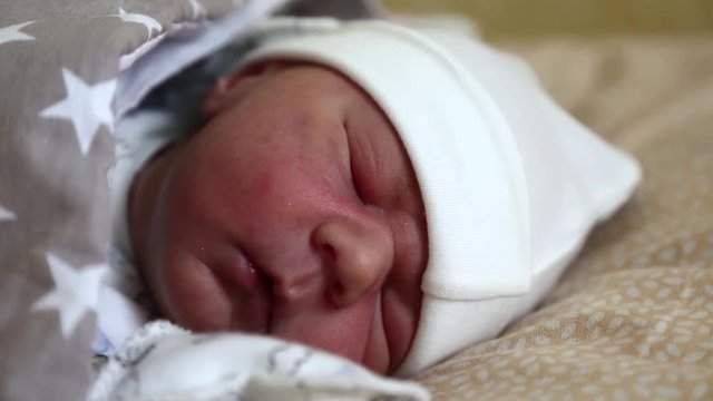 Newborn baby sleeps. Little 4 days old newborn boy lies in cot in maternity hospital. Asleep newborn baby boy