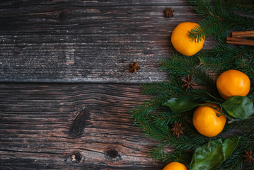 decorative Christmas frame of tangerines, fir branches, cinnamon, star anise. Winter background with copy space. Flat lay top view